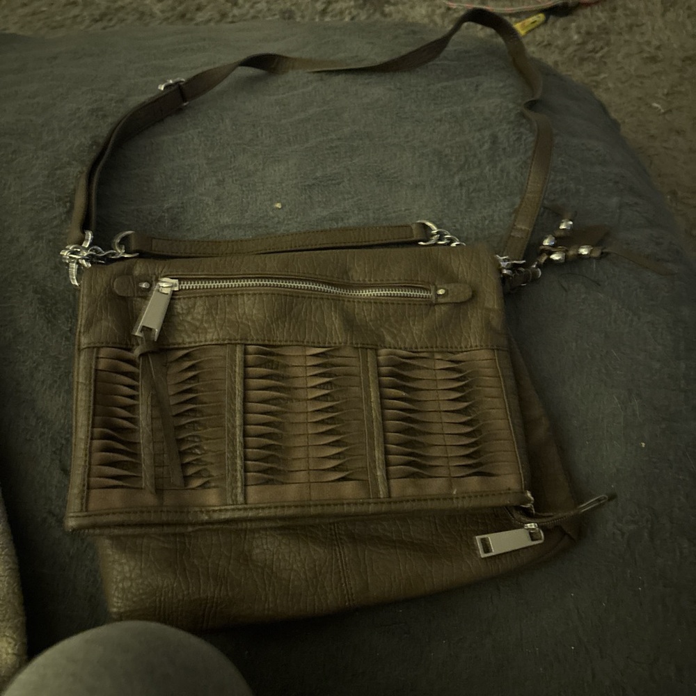 Brown faux leather shoulder bag with multiple pockets and zipper closure